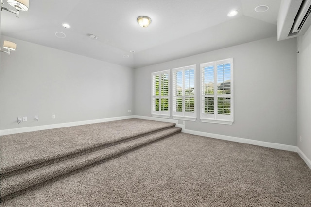 spare room with lofted ceiling and carpet flooring