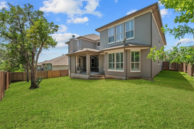 rear view of house with a lawn