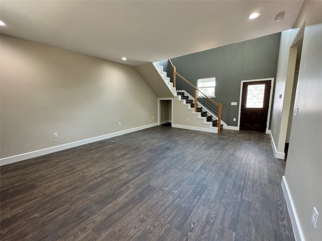 unfurnished living room with dark hardwood / wood-style flooring