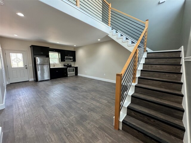 staircase with dark wood-type flooring and sink