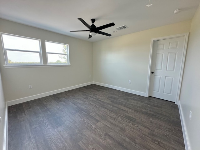 unfurnished room featuring dark hardwood / wood-style flooring and ceiling fan