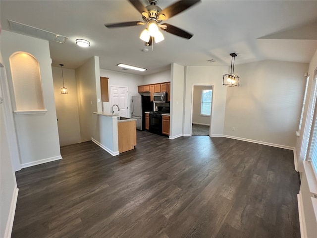 interior space with dark hardwood / wood-style floors, ceiling fan, and vaulted ceiling