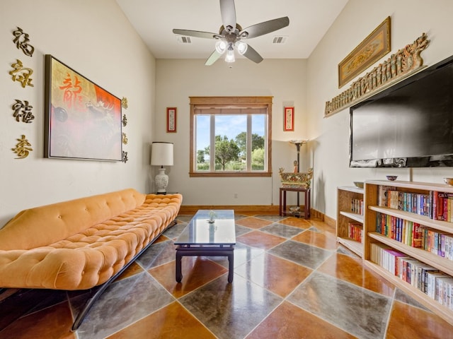 living room featuring baseboards, visible vents, and ceiling fan