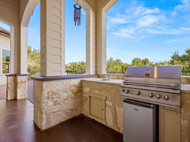 view of patio featuring exterior kitchen, grilling area, and a sink