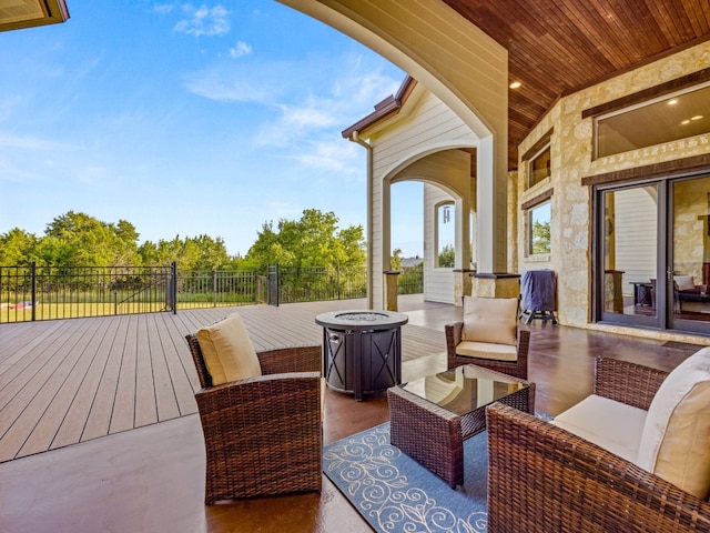 exterior space featuring an outdoor living space with a fire pit and fence