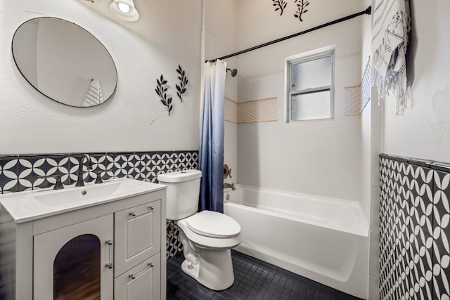 full bath with toilet, tile patterned floors, shower / bath combo with shower curtain, and vanity