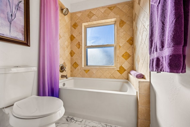 bathroom featuring toilet, marble finish floor, and shower / bath combo