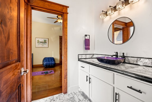 bathroom with baseboards, marble finish floor, vanity, and a ceiling fan