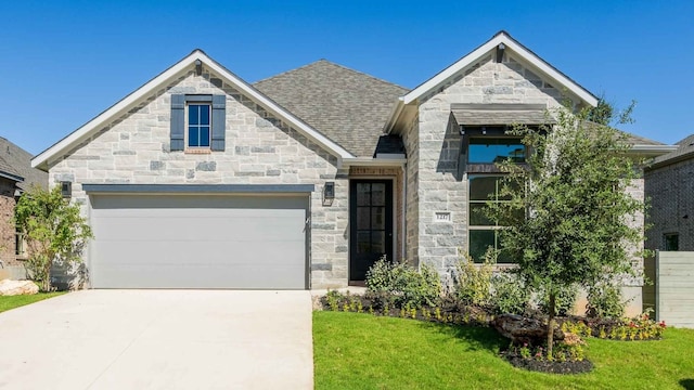 view of front of property featuring a garage and a front lawn