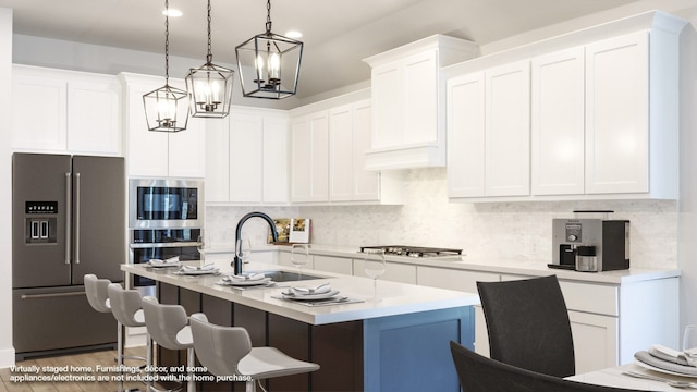 kitchen with stainless steel appliances, sink, dark hardwood / wood-style flooring, pendant lighting, and white cabinetry