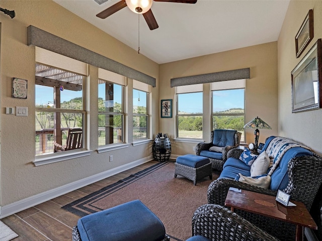 living room with ceiling fan and hardwood / wood-style flooring