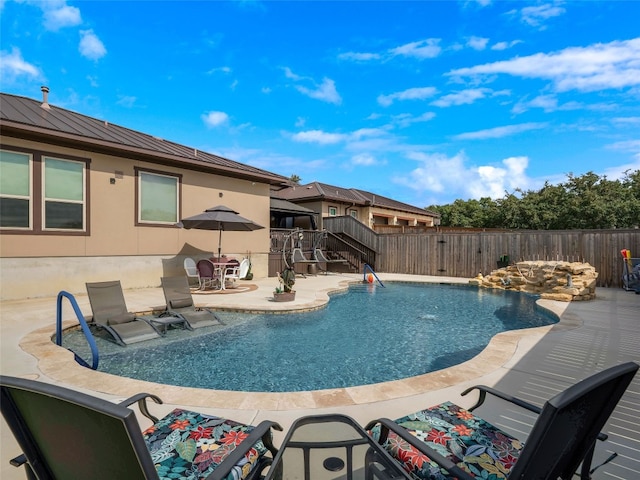 view of swimming pool with a patio area