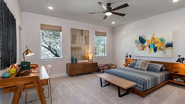 carpeted bedroom with multiple windows and ceiling fan