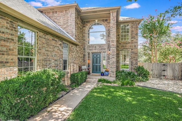 entrance to property featuring a yard