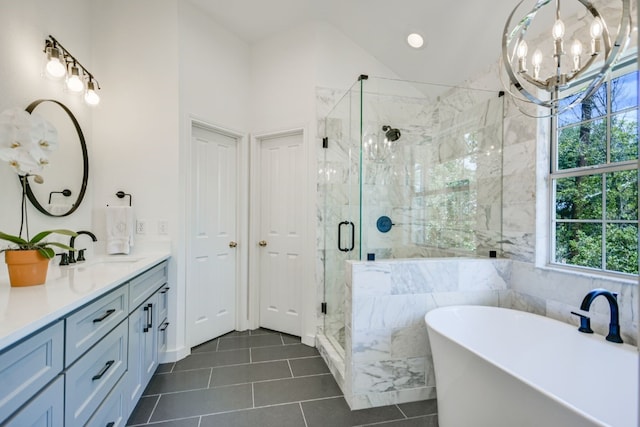 bathroom featuring independent shower and bath, tile walls, tile patterned flooring, vanity, and a notable chandelier