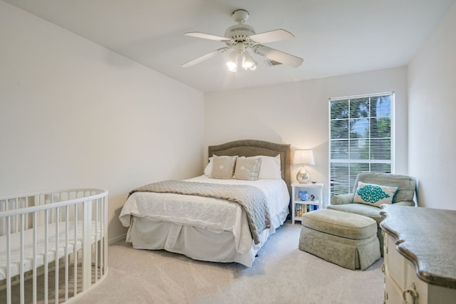 bedroom featuring light colored carpet and ceiling fan