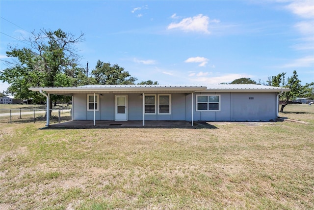 rear view of house with a yard