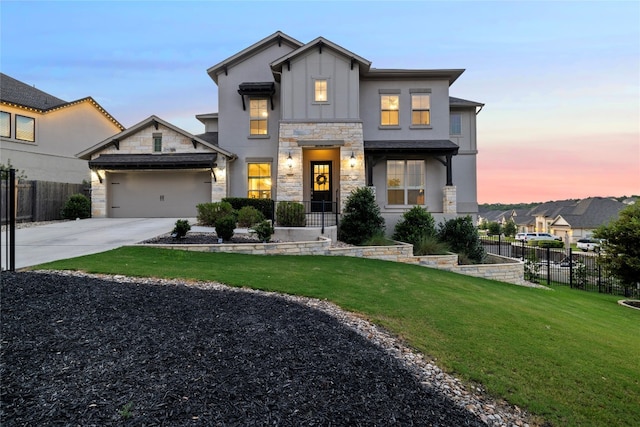 view of front of property with a garage and a lawn