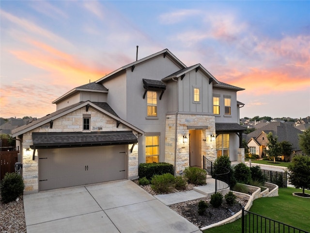 view of front of property with a garage and a yard