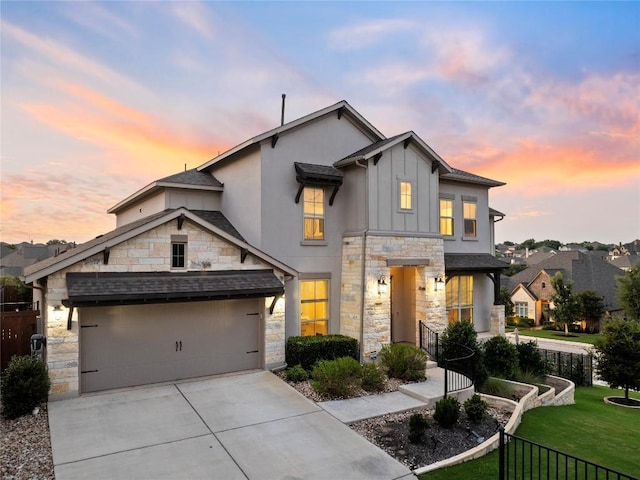 view of front of home with a garage and a yard