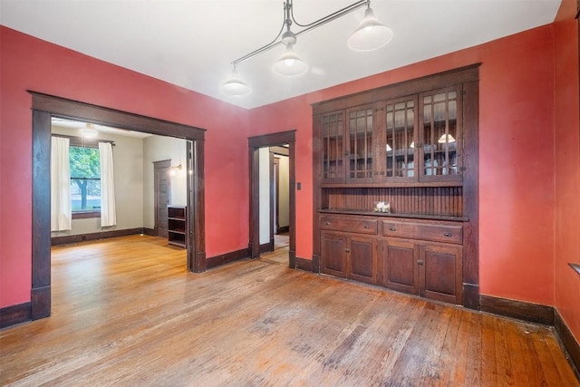 empty room with light wood-style floors and baseboards