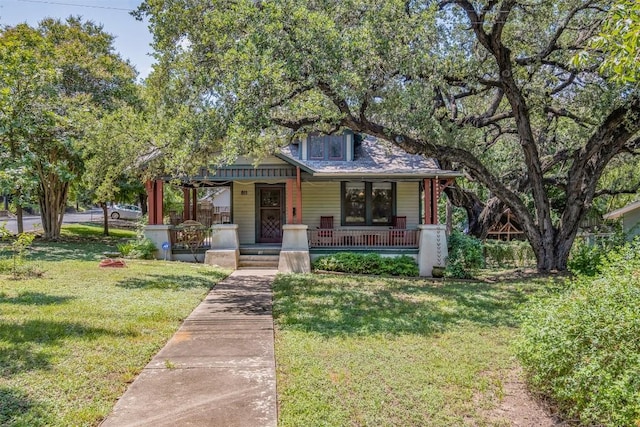 view of front of home featuring covered porch and a front lawn