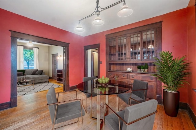 dining room with light wood-style flooring and baseboards