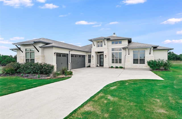 prairie-style house featuring a garage and a front yard