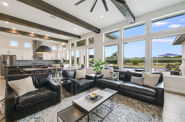 living room featuring a wealth of natural light and beamed ceiling