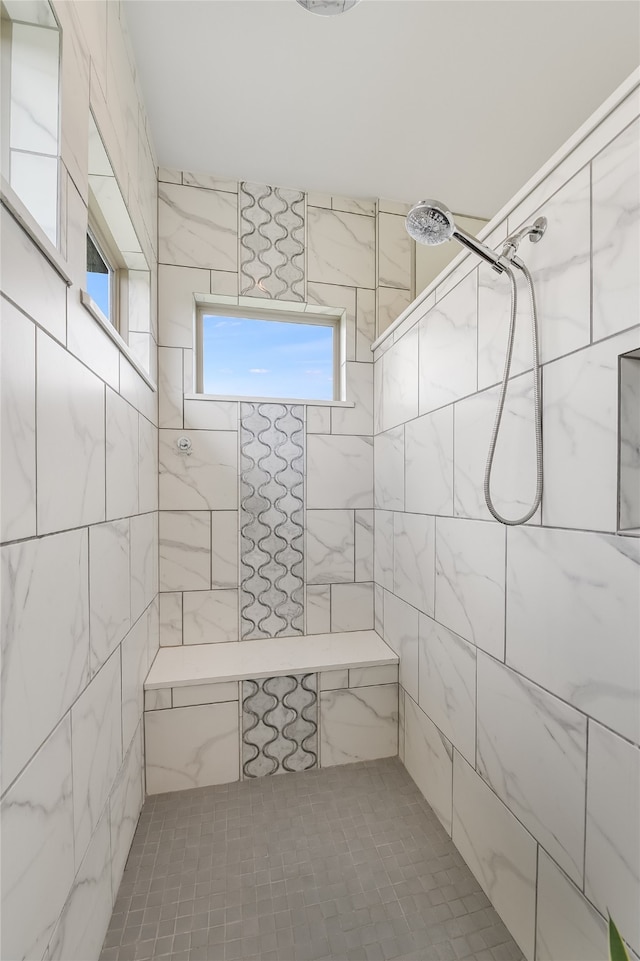 bathroom with a tile shower