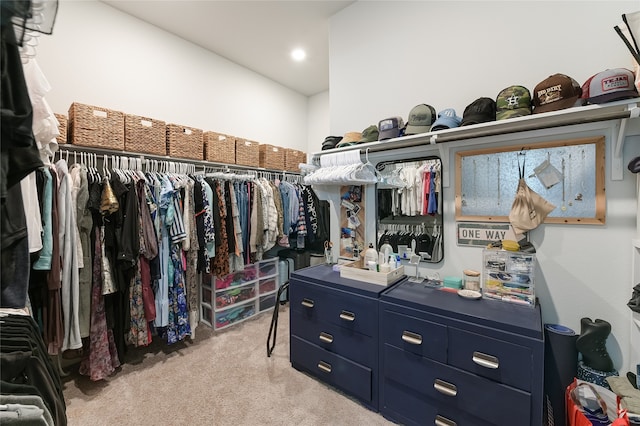 walk in closet featuring light colored carpet