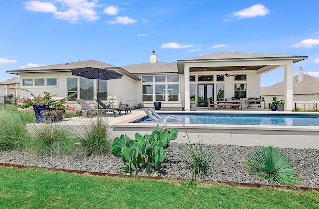 view of pool with ceiling fan, a patio area, and pool water feature