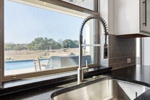 room details featuring decorative backsplash and sink