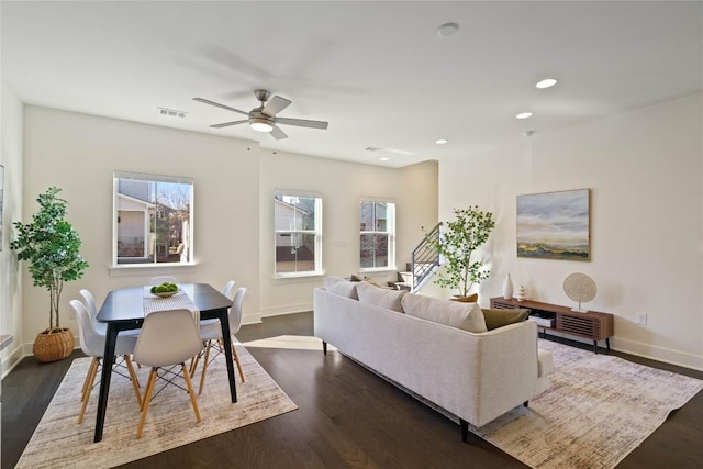 living room featuring dark hardwood / wood-style floors and ceiling fan