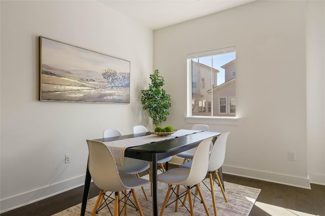 dining room with dark hardwood / wood-style flooring