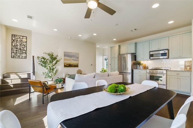 dining area featuring ceiling fan and dark hardwood / wood-style flooring