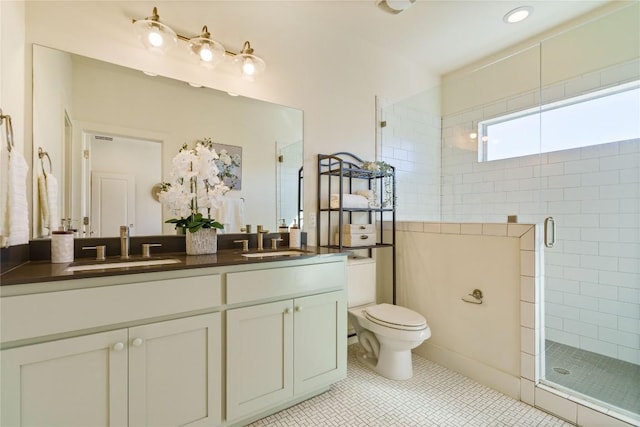 bathroom featuring tile patterned flooring, vanity, toilet, and walk in shower