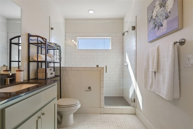 bathroom featuring tile patterned floors, vanity, an enclosed shower, and toilet