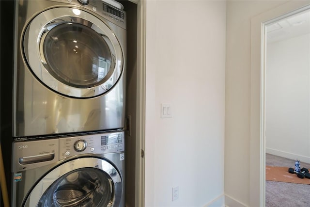 washroom featuring carpet and stacked washer and clothes dryer