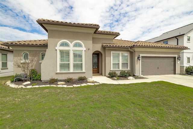 mediterranean / spanish house featuring a garage and a front yard