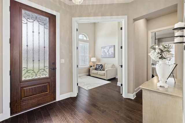 entrance foyer featuring baseboards and dark wood finished floors