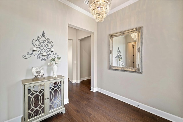 corridor with crown molding, a chandelier, and wood-type flooring