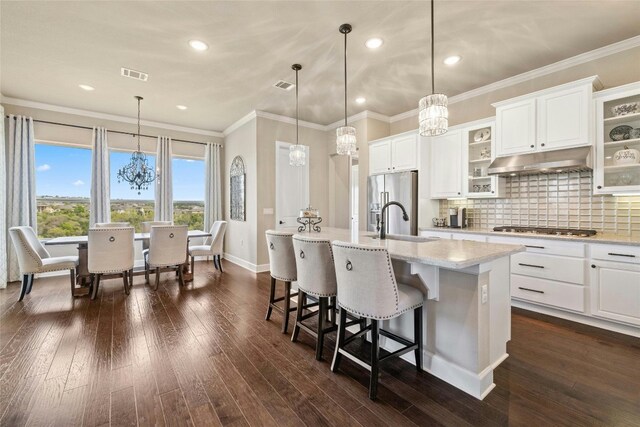 kitchen featuring dark wood-type flooring, extractor fan, fridge, and white cabinetry