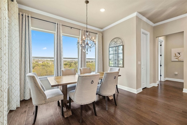 dining room featuring a chandelier, crown molding, and dark wood-type flooring