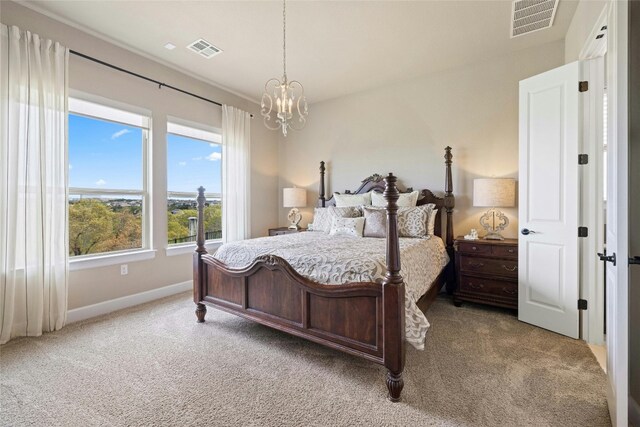 carpeted bedroom featuring visible vents, baseboards, and an inviting chandelier