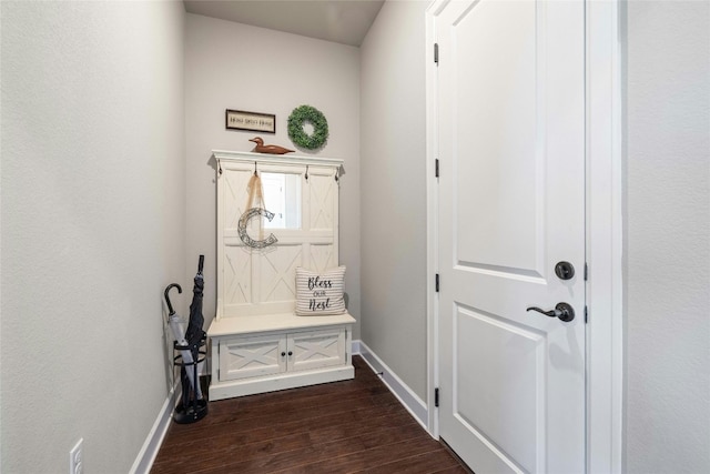 mudroom with dark wood-style flooring and baseboards