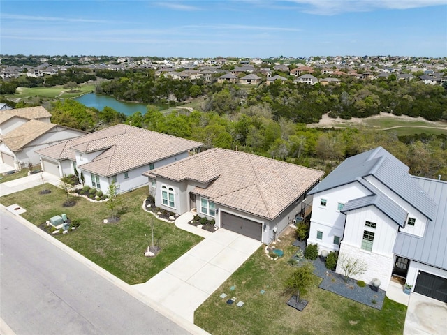 birds eye view of property with a residential view and a water view