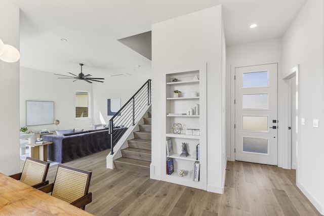 entryway with ceiling fan and light wood-type flooring