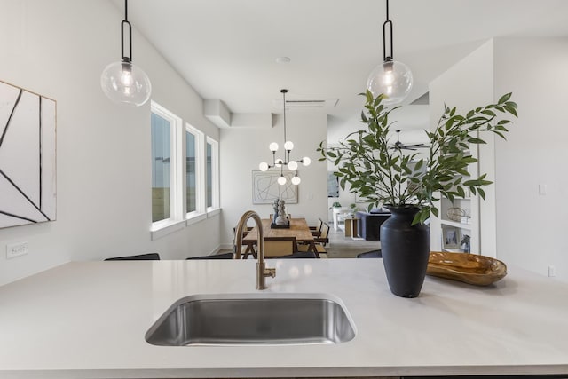 kitchen with sink, hanging light fixtures, and an inviting chandelier