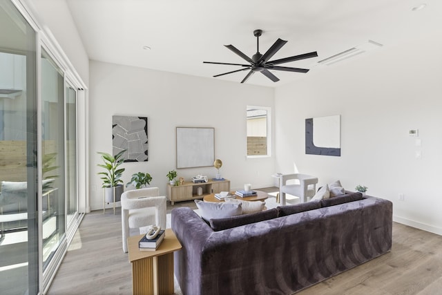 living room featuring ceiling fan and light hardwood / wood-style floors